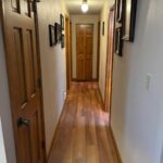 Residential Hallway with Stained Floor & Doors